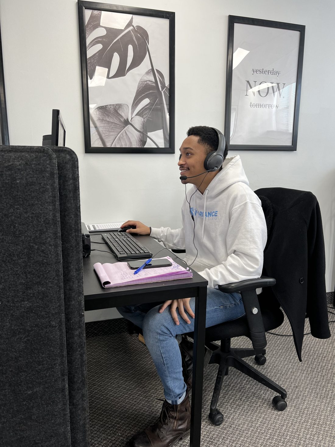 A Variance Marketing rep on a call at his desk